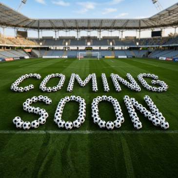 Soccer balls on grass field arranged to spell the words 'COMING SOON' near a goal in a stadium